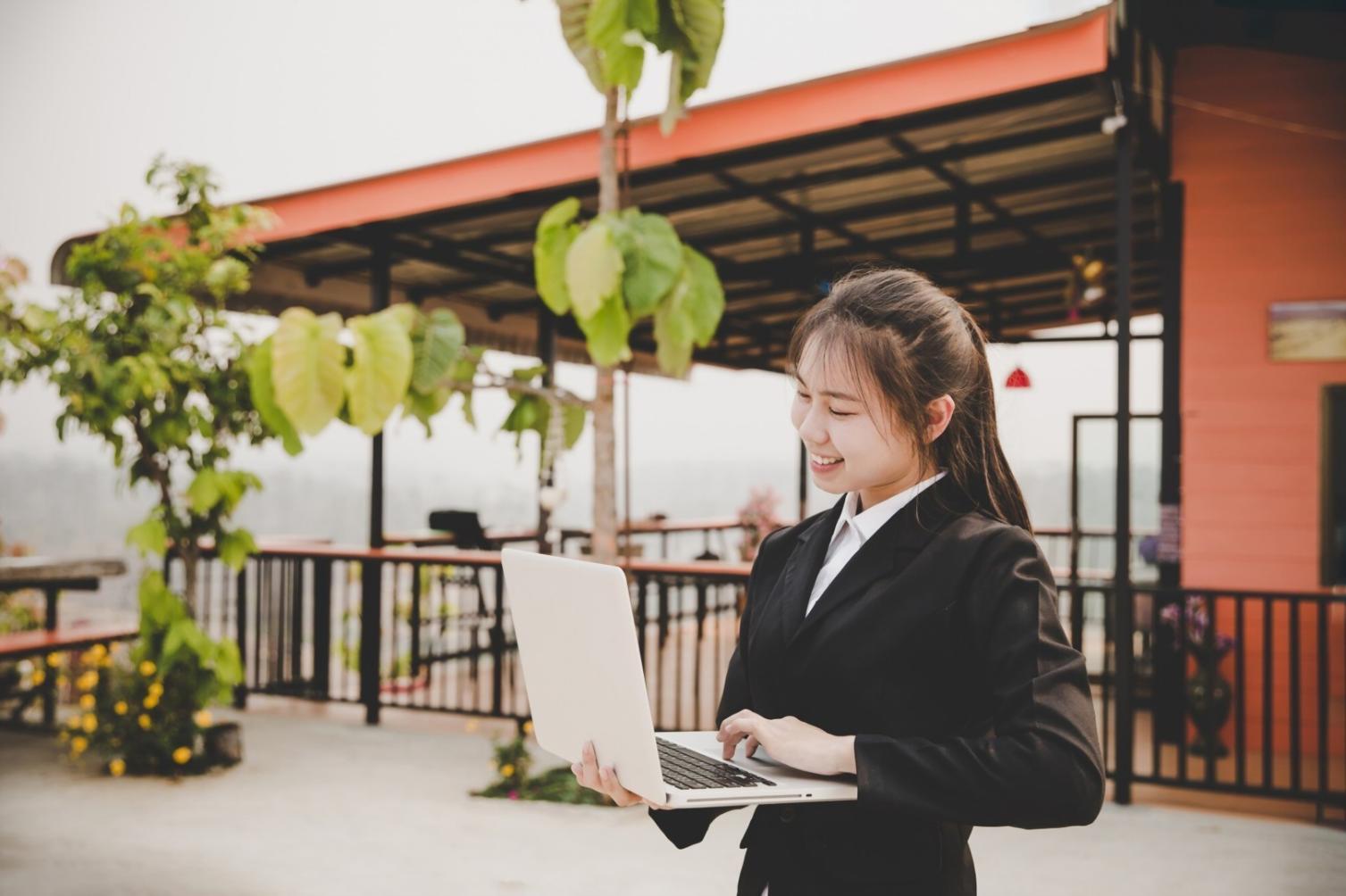 Students collaborating on blockchain project development with multiple screens showing code and testing results